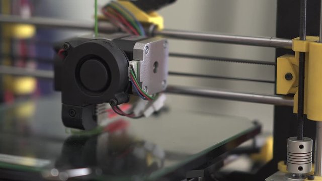 3D printer at work. 3D printing, additive manufacturing (AM), refers to processes used to create a three-dimensional object in which successive layers of material are formed under computer control