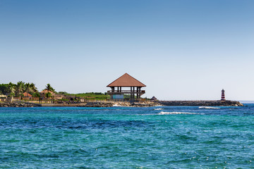 wooden house Bungalow and a lighthouse on the seashore