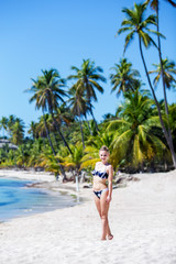 Fototapeta na wymiar happy young girl model on the empty tropical beach