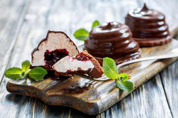 Chocolate cakes souffle with berry confit and mint on the stand.
