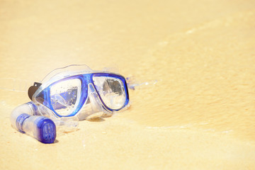 Fototapeta na wymiar Diving mask and snorkel on sand beach