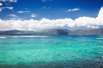 Caribbean sea surface summer wave background. Exotic water landscape with clouds on horizon. Natural tropical water paradise. Dominican Republic nature relax. Travel tropical island resort. Ocean natu