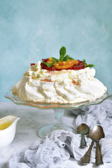 Meringue cake Pavlova with orange and citrus syrup.