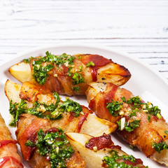 Bacon Wrapped Potatoes Wedges with Parsley Garlic Pesto Sauce. Selective focus.
