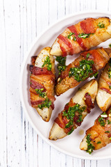 Bacon Wrapped Potatoes Wedges with Parsley Garlic Pesto Sauce. Selective focus.