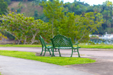 empty metal green benches in the Park
