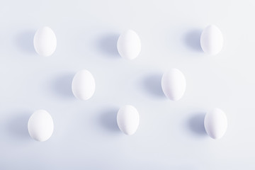 White eggs in a rows on white background