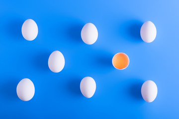 White eggs in a rows on blue background