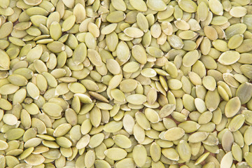 Pumpkin seeds on the wooden background