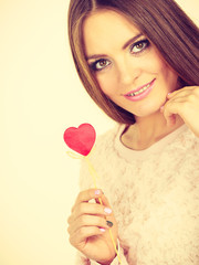 Beautiful woman holding heart shaped hand stick