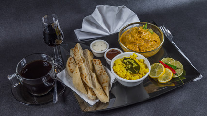 Oriental Indian set, chicken korma, naan bread, plate, coffee, liqueur, napkin, peppers, sauces