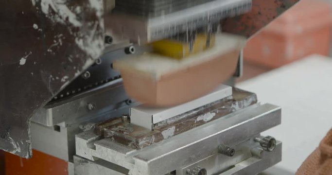 Worker operates Label Pad Printing machine