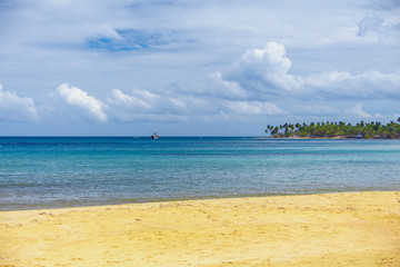 sea surf on the beach. Sand, sea, blue sky and white clouds