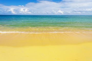 sea surf on the beach. Sand, sea, blue sky and white clouds