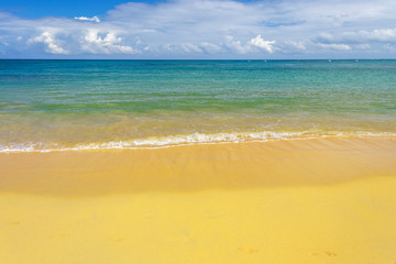 Fototapeta na wymiar sea surf on the beach. Sand, sea, blue sky and white clouds