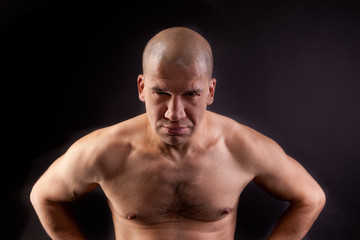 Fototapeta na wymiar Muscular young man shirtless on a black background