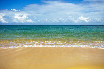 sea surf on the beach. Sand, sea, blue sky and white clouds