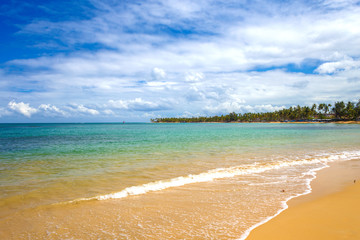 sea surf on the beach. Sand, sea, blue sky and white clouds