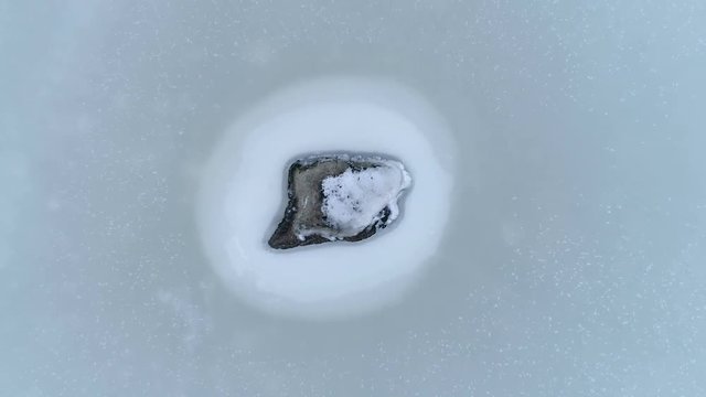 13035_Rocks_from_the_sea_shore_covered_in_thick_white_snow.mov