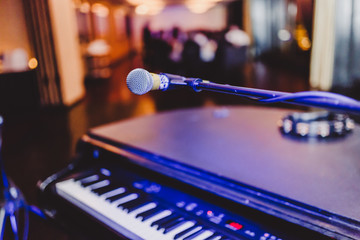 empty microphone and keyboard piano at a party
