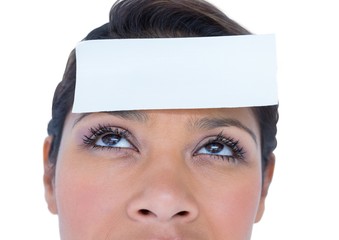 Blank paper note on a woman forehead