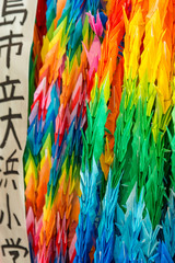 Thousand colorful origami paper cranes with a shallow depth of field
