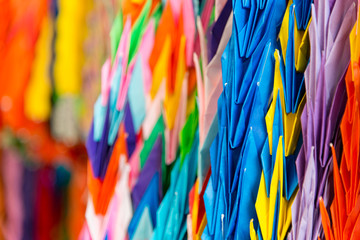 Thousand colorful origami paper cranes with a shallow depth of field