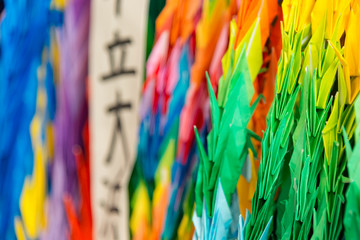 Thousand colorful origami paper cranes with a shallow depth of field