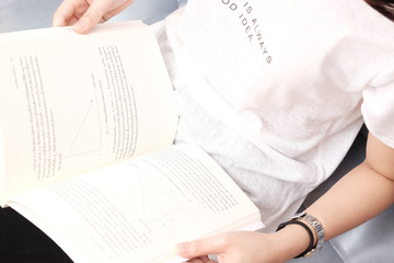 Girl sitting on sofa and reading book