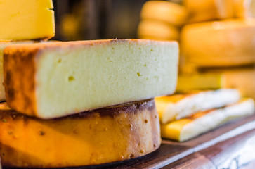 Selection of traditional Italian cheeses on a display, selective focus