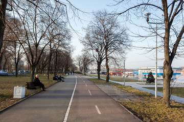 Fototapeta na wymiar Park and pedestrian zone on the bank of Danube river, in the new part of the city 