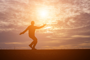 Fototapeta premium Man show hands silhouette sunset background