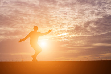 Man show hands silhouette sunset background