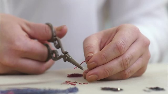 Woman hands cut the red wires on the desk