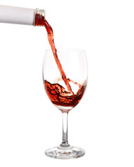 Pouring red wine into glass with splashing., Isolated white background.
