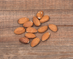 Raw organic almonds on wooden vintage tray