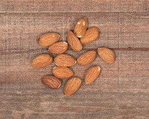Raw organic almonds on wooden vintage tray