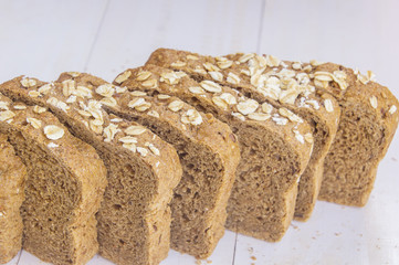 Fresh whole grain bread on white wood background