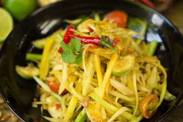 kitchen table with spicy papaya salad and ingredient food Thai national food concept of hot asian food