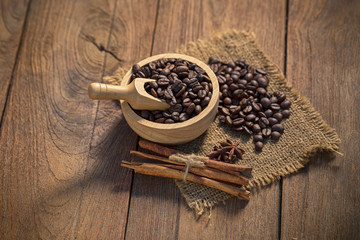 Coffee cup and coffee beans on wooden background.