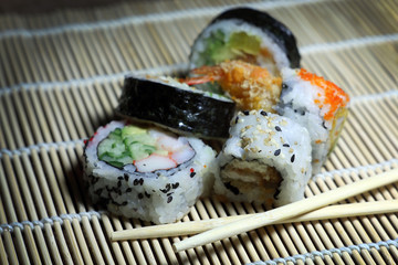 Sushi roll. Sushi roll with shrimp tempura. Fresh and delicious maki and nigiri sushi. Healthy kale and avocado sushi roll with chopsticks. Japanese food. Japanese favorite food sushi maki.