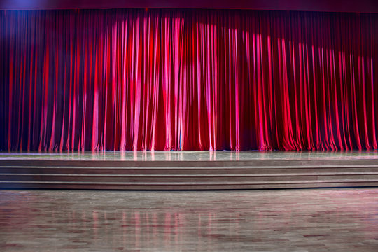 Red curtains and wooden stage.