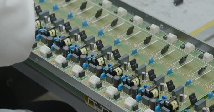 Manuall assemble parts on PCB. Closeup