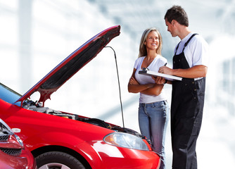 Car mechanic with client woman.