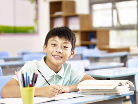 asian schoolboy studying in classroom
