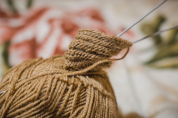 To knit spokes. A ball of woolen threads and a spoke for knitting.