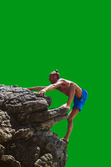 Man climbing up to mountain isolated on green background. Side view of shirtless hiker climbing up to the rock. Vertical outdoors shot.