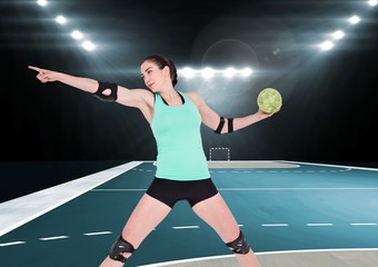 Fototapeta na wymiar Female handball player throwing ball at handball court