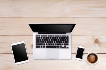 Top view laptop computer or notebook,mobile phone and cup of coffee on wooden table. Business template mock up for adding your text.