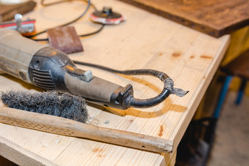The man grinds wood. The joiner processes wooden boards. Joiner's works of the house.